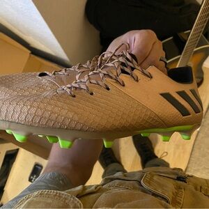 Classic Messi soccer cleats in gold and lightning green.